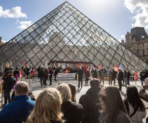epa10545203 Visitors wait outside the Louvre Museum as its employees block entrance during a demonstration to protest against the government's pension reform in Paris, France, 27 March 2023. France faces an ongoing national strike against the government's pensions reform after Prime Minister Elisabeth Borne on 16 March announced the use of article 49 paragraph 3 (49.3) of the Constitution of France to have the text on the controversial pension reform law to be definitively adopted without a vote.  EPA/CHRISTOPHE PETIT TESSON