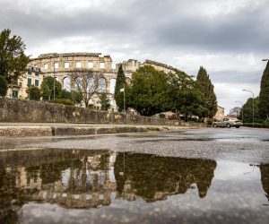 14.03.2023., Pula - Refleksije Arene u lokvicama nakon kise. Photo: Srecko Niketic/PIXSELL