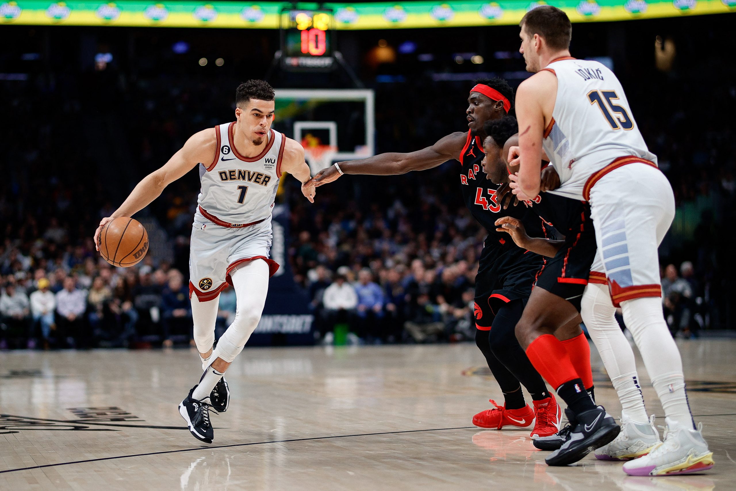 Mar 6, 2023; Denver, Colorado, USA; Denver Nuggets forward Michael Porter Jr. (1) controls the ball as center Nikola Jokic (15) screens against Toronto Raptors forward O.G. Anunoby (3) and forward Pascal Siakam (43) in the first quarter at Ball Arena. Mandatory Credit: Isaiah J. Downing-USA TODAY Sports Photo: Isaiah J. Downing/REUTERS