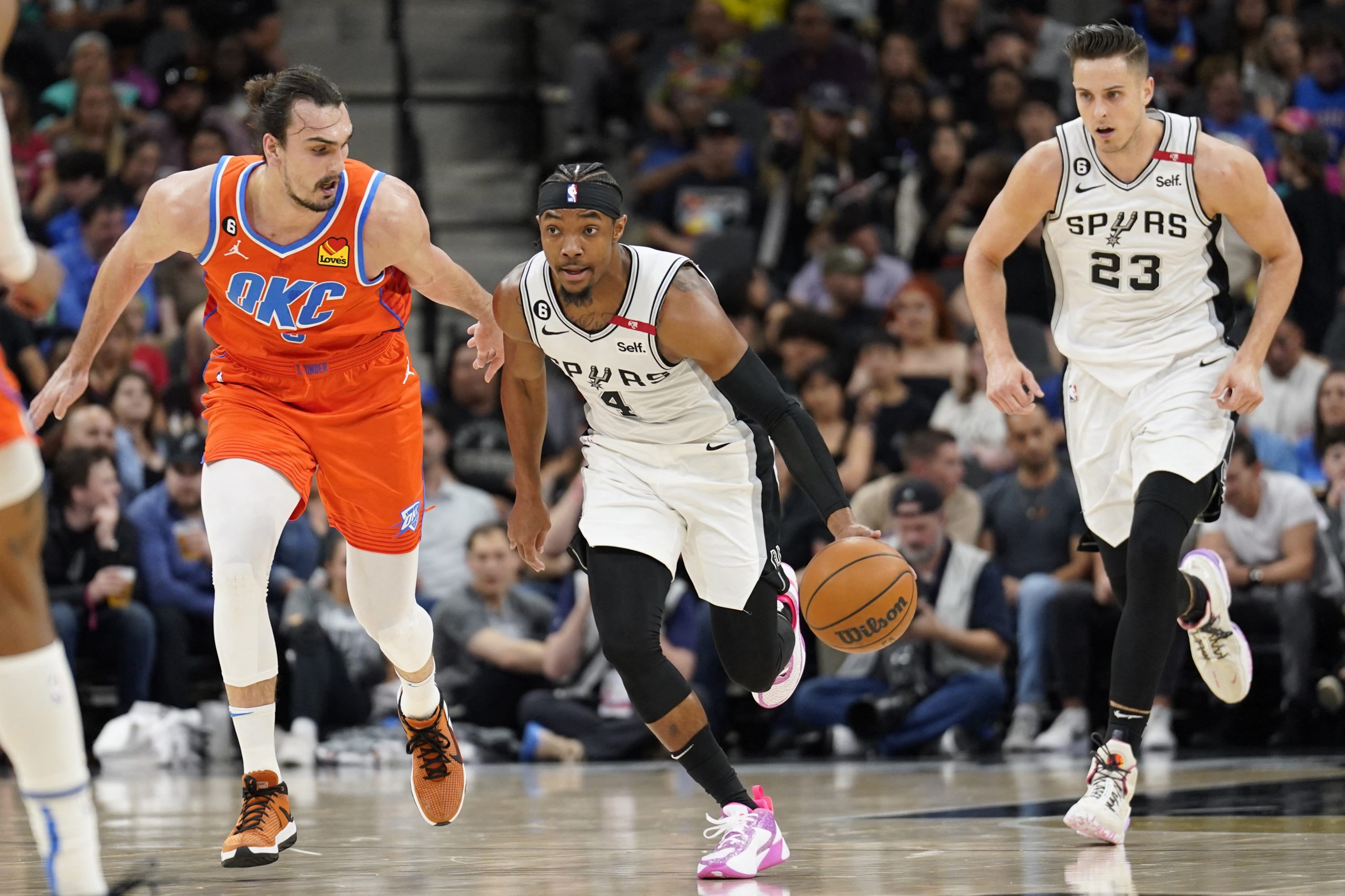 Mar 12, 2023; San Antonio, Texas, USA; San Antonio Spurs guard Devonte' Graham (4) dribbles up the court while defended by Oklahoma City Thunder forward Dario Saric (9) during the first half at AT&T Center. Mandatory Credit: Scott Wachter-USA TODAY Sports Photo: Scott Wachter/REUTERS