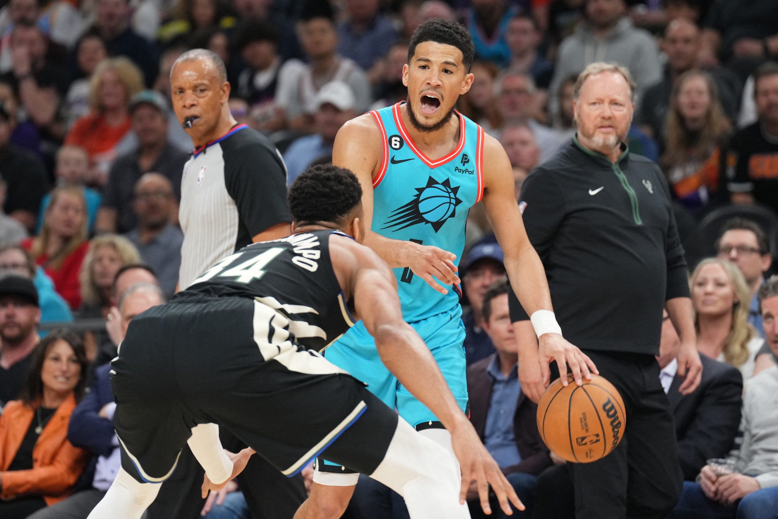 Mar 14, 2023; Phoenix, Arizona, USA; Milwaukee Bucks forward Giannis Antetokounmpo (34) guards Phoenix Suns guard Devin Booker (1) at Footprint Center. Mandatory Credit: Joe Camporeale-USA TODAY Sports Photo: Joe Camporeale/REUTERS