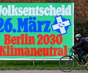 epa10534047 A cyclist passes a billboard promoting Climate Neutrality referendum in Berlin, Germany, 20 March 2023. Berlin Climate-Neutral 2030 referendum is asking the citizens to make Berlin reach its climate targets in 2030. Referendum about climate change take place on 26 March 2023.  EPA/FILIP SINGER