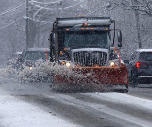 epa10522975 A snow plow operator clears the streets as snow falls in Woburn, Massachusetts, USA, 14 March 2023. A nor'easter winter storm brought significant rain fall and then snow accumulations of nearly two feet (61cm) in some communities west of Boston.  EPA/CJ GUNTHER