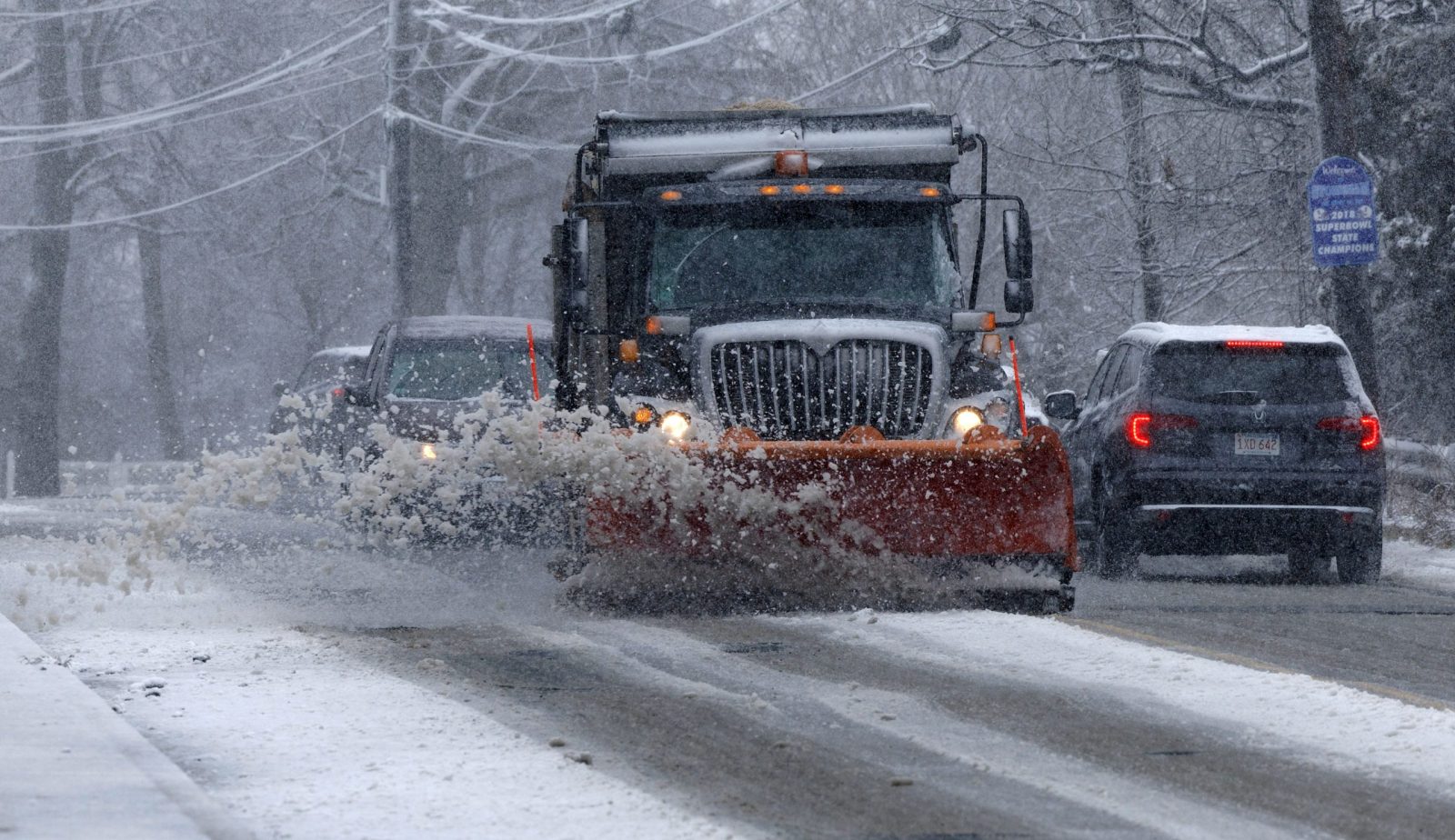 epa10522975 A snow plow operator clears the streets as snow falls in Woburn, Massachusetts, USA, 14 March 2023. A nor'easter winter storm brought significant rain fall and then snow accumulations of nearly two feet (61cm) in some communities west of Boston.  EPA/CJ GUNTHER
