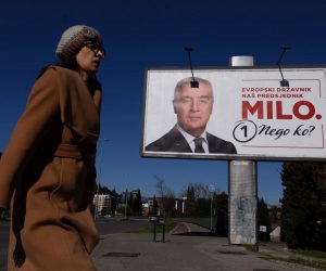 epa10528207 A woman walks past a campaign billboard of the Presidential candidate and incumbent President Milo Djukanovic ahead of the upcoming Presidential elections in Podgorica, Montenegro, 17 March 2023. Presidential elections are due to be held in Montenegro on 19 March 2023.  EPA/BORIS PEJOVIC