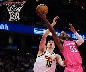 epa10537769 Washington Wizards guard Delon Wright (R) and Denver Nuggets centre Nikola Jokic (L) during the first half of the NBA basketball game between the Washington Wizards and Denver Nuggets, at Capital One Arena, in Washington, DC, USA, 22 March 2023.  EPA/WILL OLIVER SHUTTERSTOCK OUT