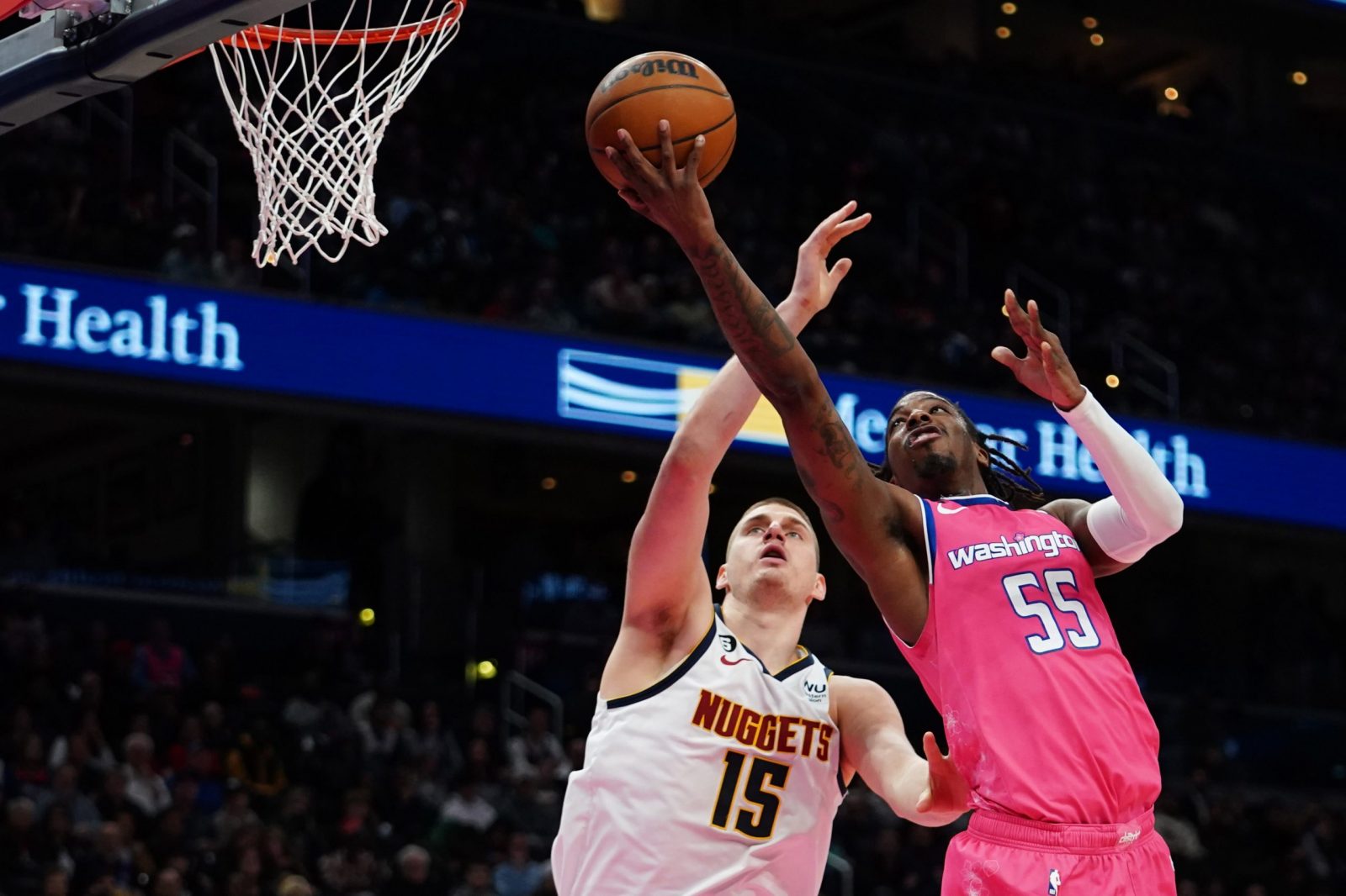 epa10537769 Washington Wizards guard Delon Wright (R) and Denver Nuggets centre Nikola Jokic (L) during the first half of the NBA basketball game between the Washington Wizards and Denver Nuggets, at Capital One Arena, in Washington, DC, USA, 22 March 2023.  EPA/WILL OLIVER SHUTTERSTOCK OUT