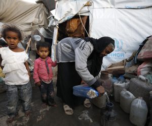 epa10541342 Yemeni children stand next to their grandmother at a makeshift camp for Internally Displaced Persons (IDPs) in Sana'a, Yemen, 23 March 2023 (issued 24 March 2023). More than 11 million children in Yemen require urgent humanitarian aid as they could face greater risks of malnutrition due to the consequences of eight years of the endless and crushing war in the Arab country, the United Nations Children's Agency (UNICEF) has warned. The protracted war in Yemen is referred to as the Saudi Arabia-Iran proxy conflict in which the warring parties have been militarily and politically backed by Saudi Arabia and Iran respectively since 2015.  EPA/YAHYA ARHAB
