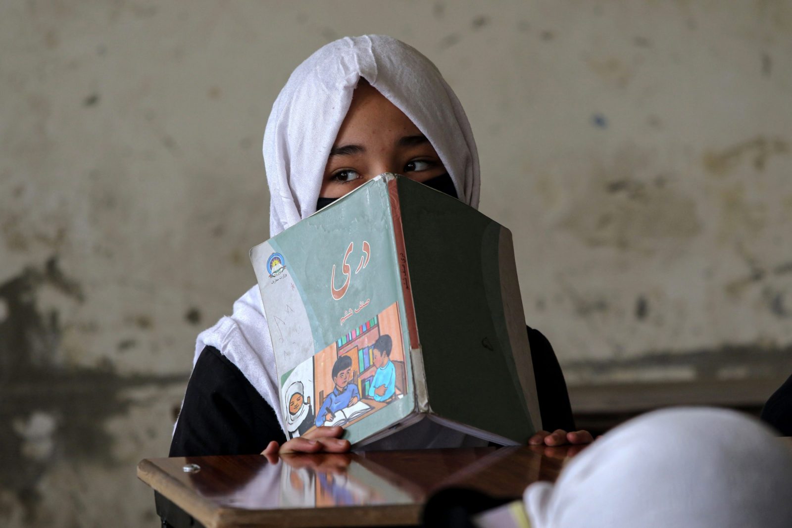 epa10543340 A schoolgirl attending up to primary grade classes sits in a classroom at the start of the new academic year in Kabul, Afghanistan, 25 March 2023. As schools reopen across the country, hundreds of thousands of teenage girls will not be able to go to classes after Taliban authorities banned female students from secondary education. UNICEF urged authorities to lift the ban on girls' and women's further education in a statement on 21 March 2023.  EPA/SAMIULLAH POPAL