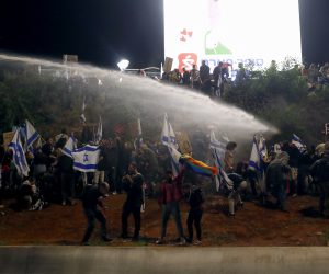 epa10554319 Police use water canons to disperse demonstrators in Ayalon highway during a protest against the government's justice system reform plans in Tel Aviv, Israel, 01 April 2023. Israeli prime minister announced on 27 March his government's suspension of a judicial overhaul legislation and starting negotiations with opposition leaders after 12 weeks of mass protests across the country.  EPA/ATEF SAFADI