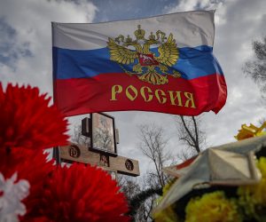 epa10561989 A Russia flag flies on a flower decorated garve of a Russian serviceman on the cemetery near the town Yefremov, Tula region, Russia, 06 April 2023.  EPA/MAXIM SHIPENKOV