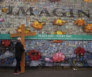 epa10563272 A man walks with a cross as residents from the Falls and Shankill Roads create a Human Peacewall at Northumberland Street to form a line of solidarity between the two communities to mark the 25th anniversary of the Northern Ireland Agreement in Belfast, Northern Ireland, Britain, 7 April 2023. The Good Friday Agreement was signed on 10 April 1998. The agreement ended the violent phase of the political conflict in Northern Ireland and is seen as the major development in the Northern Ireland peace process of the 1990s.  EPA/MARK MARLOW