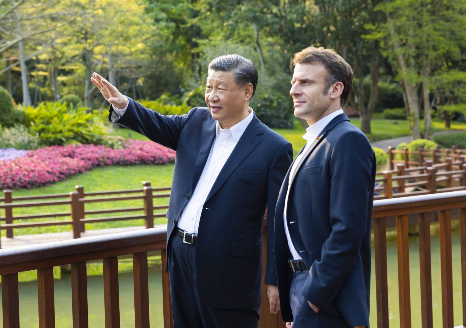 epa10564460 Chinese President Xi Jinping (L) and French President Emmanuel Macron (R) chat during a stroll through the Pine Garden in Guangzhou, Guangdong Province, China, 07 April 2023 (issued 08 April 2023).  https://www.politico.eu/article/china-skeptic-mps-emmanuel-macron-speak-europe/ CHINA OUT / MANDATORY CREDIT  EDITORIAL USE ONLY