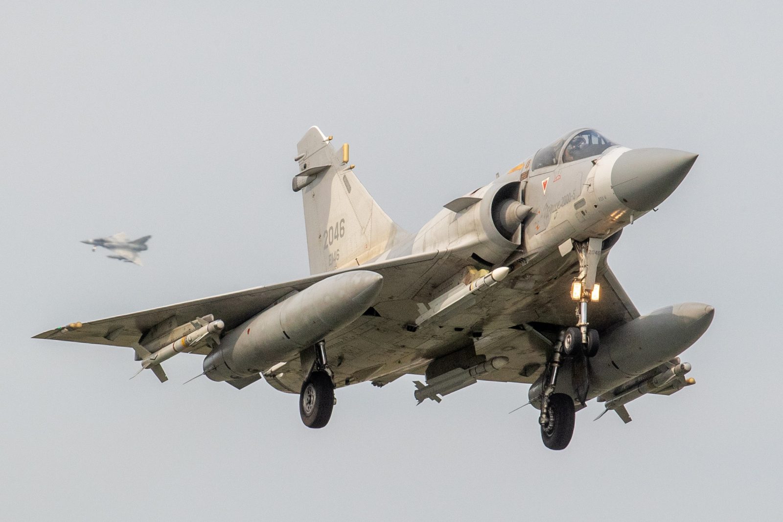 epa10565834 Taiwan Air Force Mirage 2000 fighter jets approach for landing inside the airbase in Hsinchu, Taiwan, 09 April 2023. China announced three days of military drills around Taiwan and flew dozens of planes across the Taiwan Strait median line, following the Taiwanese president’s visit to the United States.  EPA/RITCHIE B. TONGO
