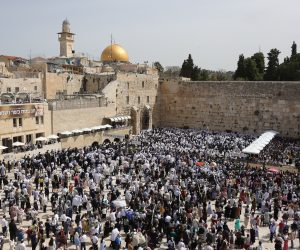 epa10565900 Orthodox Jews cover their heads with prayer shawls as they recite the 'Priestly Blessing' or Cohanim prayer in Hebrew on the holiday of Passover, in front of the Western Wall, in Jerusalem, 09 April 2023. The prayer, which is performed twice a year, is only spoken by the Cohanim, the high priests of the ancient temples during the week-long Jewish holiday of Passover, commemorating the Jewish exodus from Egypt in Biblical times.  EPA/ABIR SULTAN