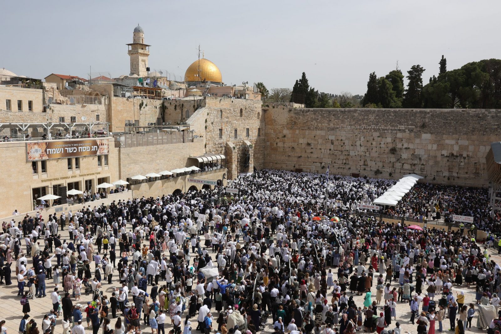 epa10565900 Orthodox Jews cover their heads with prayer shawls as they recite the 'Priestly Blessing' or Cohanim prayer in Hebrew on the holiday of Passover, in front of the Western Wall, in Jerusalem, 09 April 2023. The prayer, which is performed twice a year, is only spoken by the Cohanim, the high priests of the ancient temples during the week-long Jewish holiday of Passover, commemorating the Jewish exodus from Egypt in Biblical times.  EPA/ABIR SULTAN