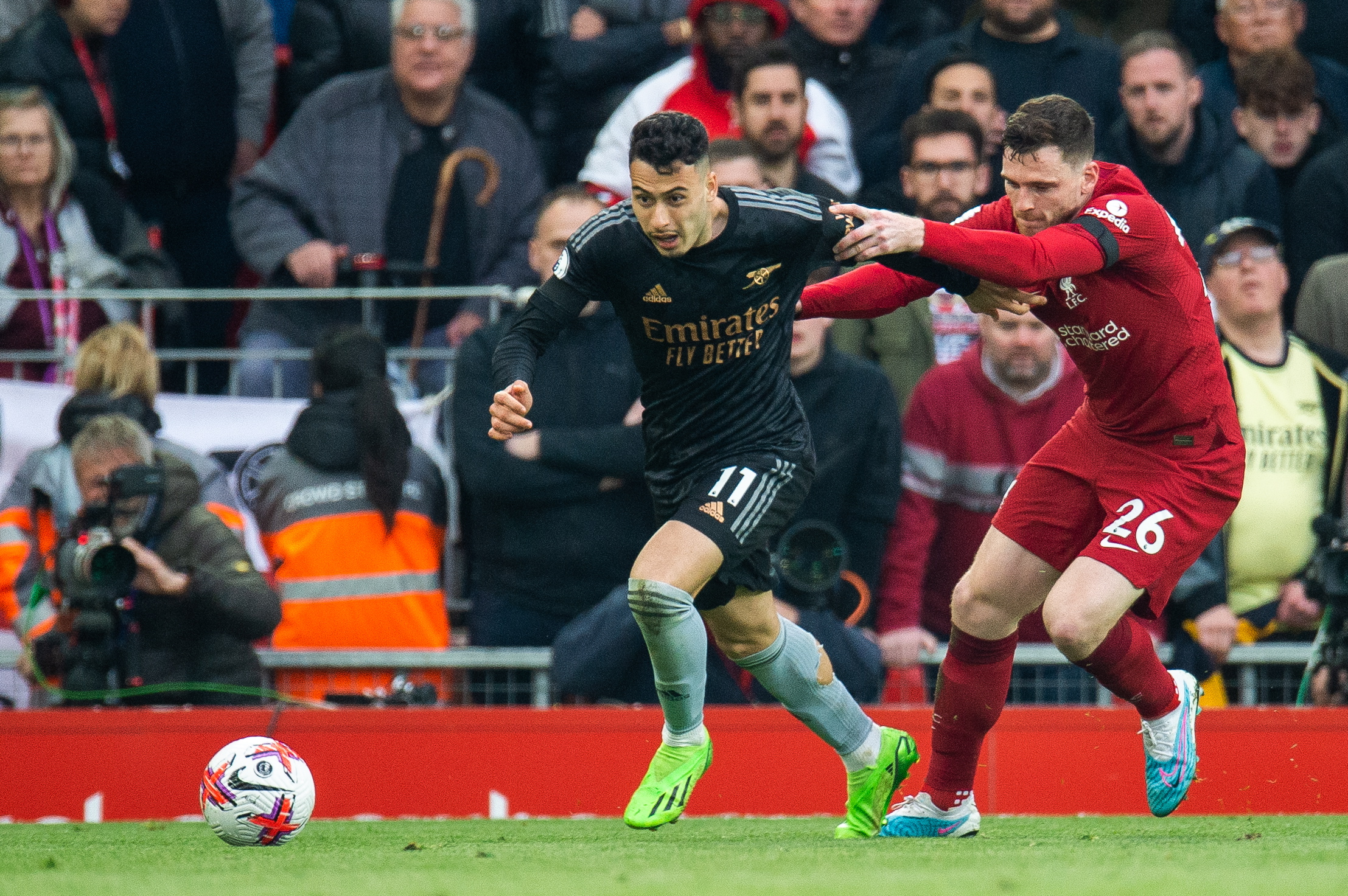 epa10566549 Arsenal's Gabriel Martinelli (L) in action with Liverpool's Andy Robertson (R) during the English Premier League soccer match between Liverpool and Arsenal at Anfield in Liverpool, Britain, 09 April 2023.  EPA/PETER POWELL EDITORIAL USE ONLY. No use with unauthorized audio, video, data, fixture lists, club/league logos or 'live' services. Online in-match use limited to 120 images, no video emulation. No use in betting, games or single club/league/player publications