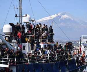 epa10569476 Some of the 600 migrants rescued on a trawler some 100 miles of the coast of Sicily arrive in the port of Catania, Italy, 12 April 2023. The vessel was escorted by the 'Nave Peluso' of the Coast Guard on the same day after over 200 people rescued at sea also landed in Catania and Messina on two other Coast Guard vessels. The Italian government on 11 April called a state of emergency on all the national territory following the exceptional rise in migrant flows across the Mediterranean.  EPA/ORIETTA SCARDINO