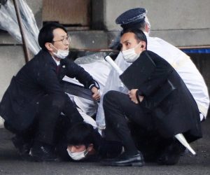 epa10573225 Police officers arrest a man suspected to have thrown explosives as Japanese Prime Minister Fumio Kishida was about to make a stump speech at a fishing port in Wakayama, Wakayama Prefecture, western Japan, 15 April 2023. A loud explosion was heard just before Kishida was set to speak. Kishida was not harmed in the explosion and police forces arrested the suspect believed to have thrown the explosive.  EPA/JIJI PRESS JAPAN OUT EDITORIAL USE ONLY / ALTERNATE CROP