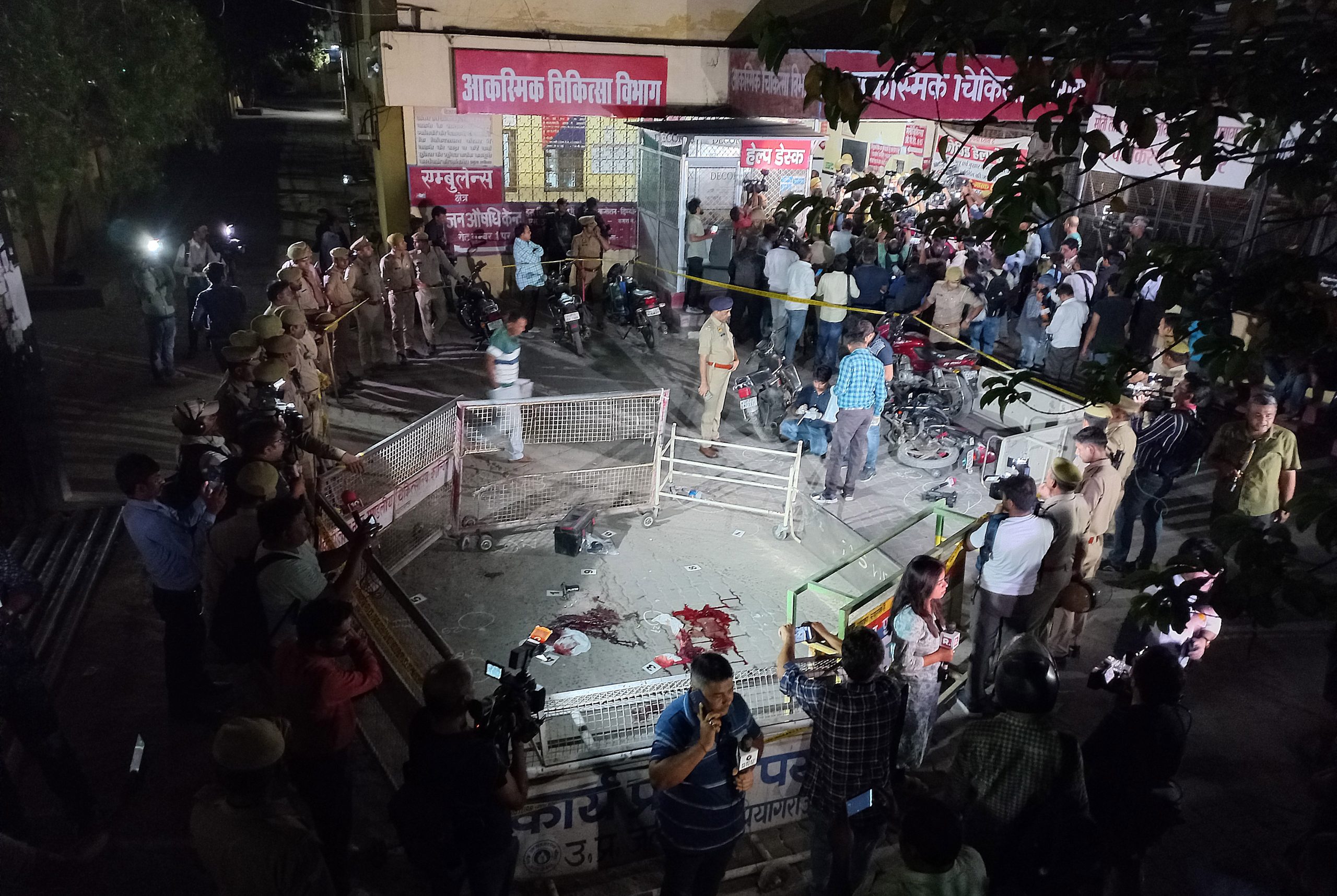 epa10575296 Government officials and police officers investigate the crime scene where India's former MP Atiq Ahmed was killed along with his brother, at the MLN Medical College premises in Prayagraj (Allahabad), India, late 15 April 2023 (issued 16 April 2023). Jailed former politician Atiq Ahmed and his brother were shot dead on 15 April while talking to reporters on live TV on their way to a medical check-up. Ahmed died two days after his son Asad was killed during an encounter with the Uttar Pradesh Special Task Force (STF) in connection to a murder case.  EPA/PRABHAT KUMAR VERMA