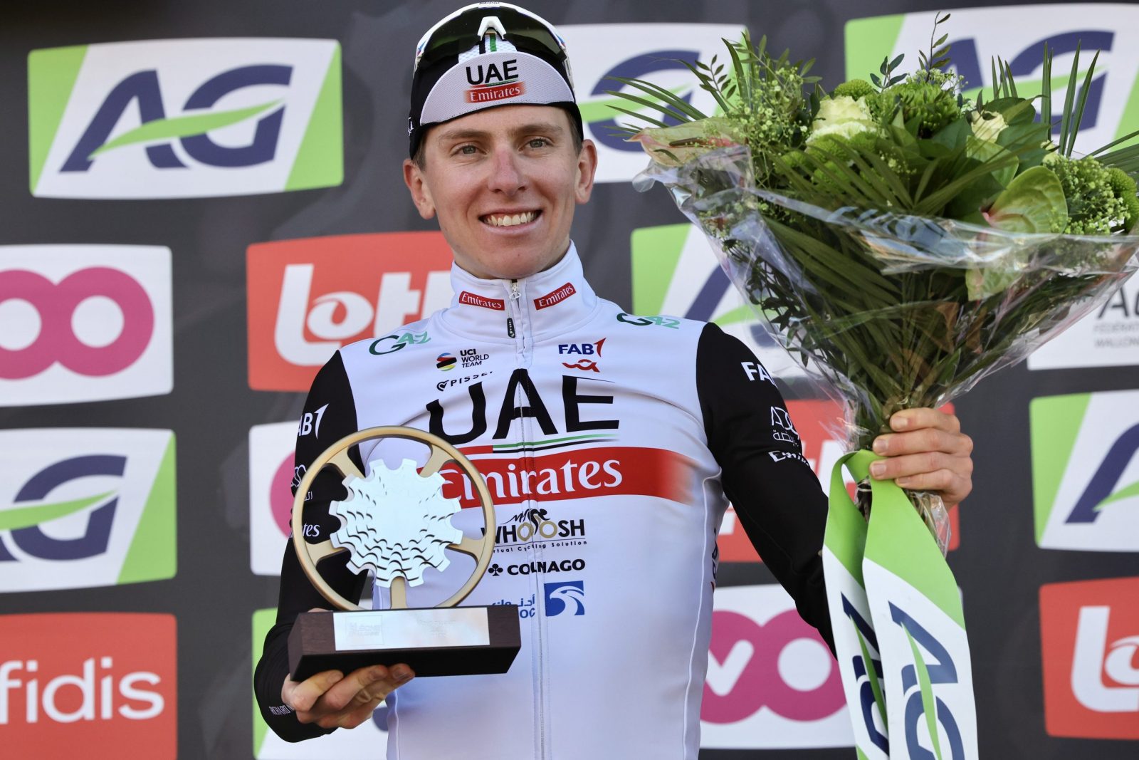 epa10580236 Slovenian rider Tadej Pogacar of UAE Team Emirates celebrates on the podium after winning the Fleche Wallonne cycling race over 194.2km from Herve to Huy, Belgium, 19 April 2023.  EPA/OLIVIER MATTHYS
