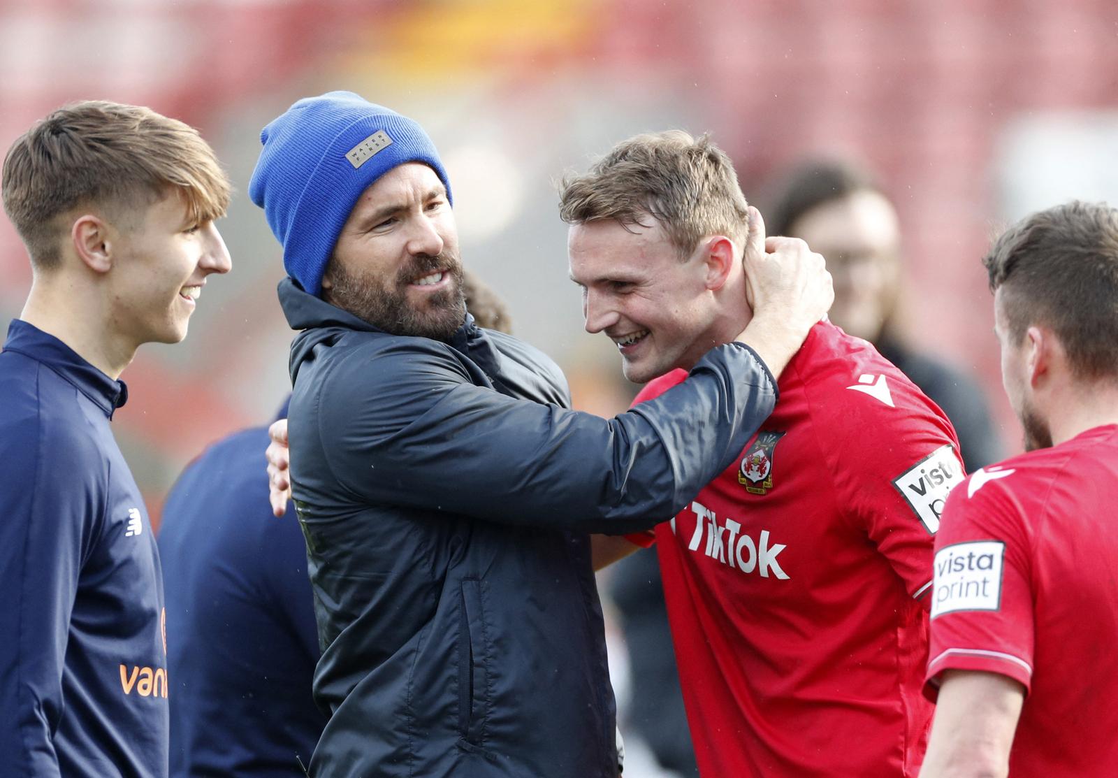 Soccer Football - National League - Wrexham v Notts County - Racecourse Ground, Wrexham, Britain - April 10, 2023 Wrexham co-owners Ryan Reynolds celebrates after winning the match with players Action Images via Reuters/Andrew Boyers EDITORIAL USE ONLY. No use with unauthorized audio, video, data, fixture lists, club/league logos or 'live' services. Online in-match use limited to 75 images, no video emulation. No use in betting, games or single club /league/player publications.  Please contact your account representative for further details. Photo: Andrew Boyers/REUTERS