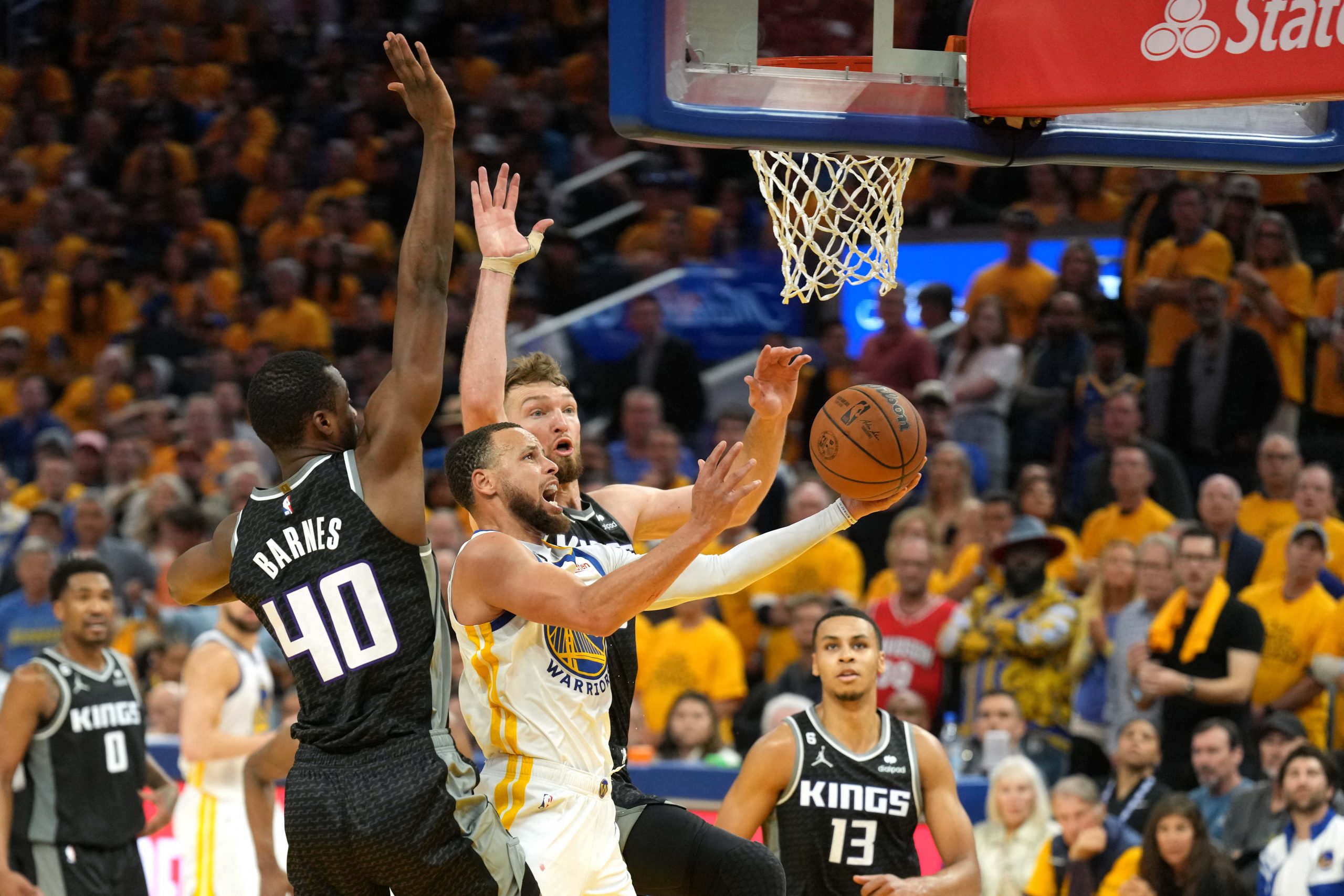 Apr 23, 2023; San Francisco, California, USA; Golden State Warriors guard Stephen Curry (center front) shoots against Sacramento Kings forward Harrison Barnes (40) and forward Domantas Sabonis (center back) during the fourth quarter of game four of the 2023 NBA playoffs at Chase Center. Mandatory Credit: Darren Yamashita-USA TODAY Sports Photo: Darren Yamashita/REUTERS
