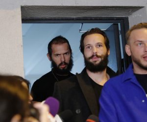 epa10553031 Controversial social media influencer Andrew Tate (L) and his brother Tristan (C) exit the police arrest building, assisted by their lawyer Constantin Eugen Vidineac  (R), as they were moved from police custody to house arrest with immediate effect, as a Romanian judge has ruled, in Bucharest, Romania, 31 march 2023. Two associates, Georgiana Naghel and Luana Radu, were also being released. All four have been ordered to stay in the buildings where they live, unless they have judicial permission to leave. On 29 December 2022, Andrew Tate and his brother Tristan were arrested as a result of the DIICOT inquiry under the charges of human trafficking and intention to form an organized crime group. Romanian police stated that the two brothers and their associates coerced victims for creating a paid pornography service for social media platforms.  EPA/Robert Ghement