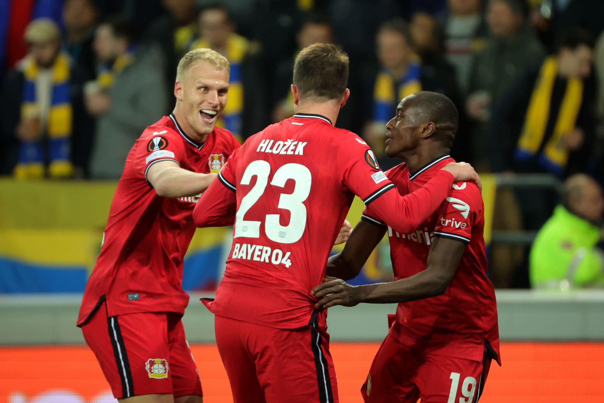 epa10582738 Adam Hlozek of Leverkusen (R2) celebrates with teammates Mitchel Bakker (L) and Moussa Diaby (R) after scoring the 1-4 during the UEFA Europa League quarter final, 2nd leg match between Union Saint-Gilloise and Bayer Leverkusen in Brussels, Belgium, 20 April 2023.  EPA/OLIVIER MATTHYS