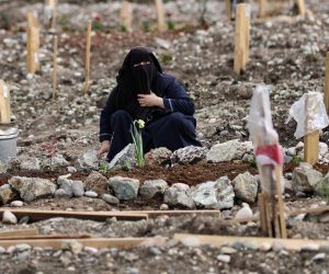 epa10536865 A woman mourns at the graves of her relatives at the Kapicam cemetery on the eve of Ramadan, in the aftermath of a powerful earthquake in Kahramanmaras, Turkey, 22 March 2023. More than 50,000 people died and thousands more were injured after major earthquakes struck southern Turkey and northern Syria on 06 February and again on 20 February 2023.  EPA/ERDEM SAHIN