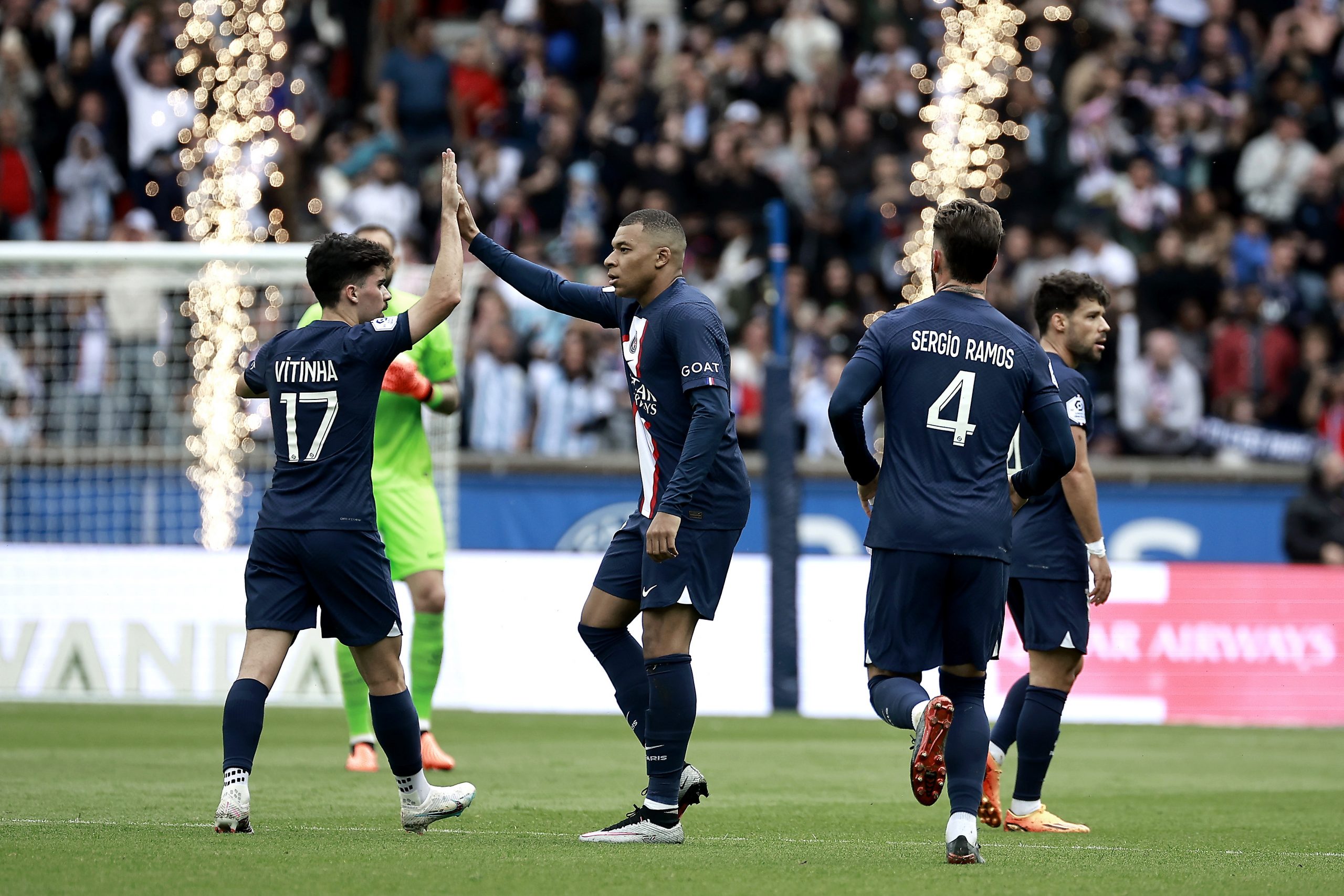 epa10600487 Paris Saint Germain's Kylian Mbappe (C) celebrates with Paris Saint Germain's Vitinha after scoring the 1-1 goal during the French Ligue 1 soccer match between Paris Saint Germain and FC Lorient in Paris, France, 30 April 2023.  EPA/CHRISTOPHE PETIT TESSON