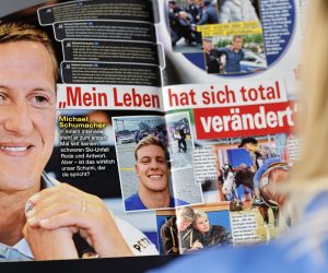 epa10581740 A woman reads the edition of German weekly magazine Die Aktuelle with the cover announcing a fake interview with Michael Schumacher, in Berlin, Germany, 20 April 2023. A spokesperson for the Schumacher family announced to take legal actions against the magazine that runs their cover with a story with a picture of Schumacher and under the headline "Michael Schumacher, the first interview" which was generated by an artificial intelligence (AI) chatbot. Formula One legend Schumacher retreated from public life following a skiing accident in the French Alps in 2013 and his family has remained protective of his privacy.  EPA/HANNIBAL HANSCHKE