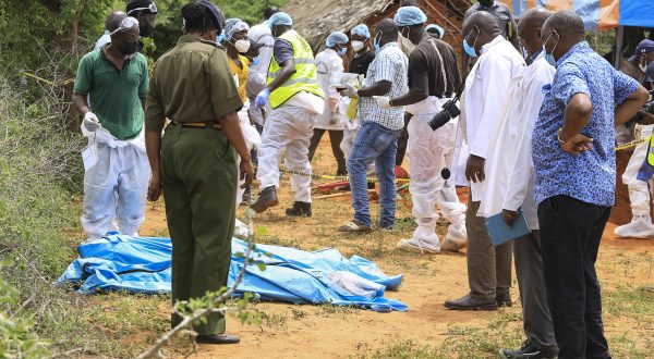 epa10588064 Kenyan homicide detectives and forensic experts from the Directorate of Criminal Investigations (DCI), examine exhumed bodies from several shallow mass graves of suspected members of a Christian cult after starving themselves to death, after allegedly being told by their controversial preacher Paul Mackenzie that they would go to heaven if they starved themselves to death, in the coastal Shakahola forest, in Kilifi, Kenya, 23 April 2023. According to the Police, 18 more bodies were exhumed on 23 April bringing the tally of bodies recovered to at 39.  EPA/STR