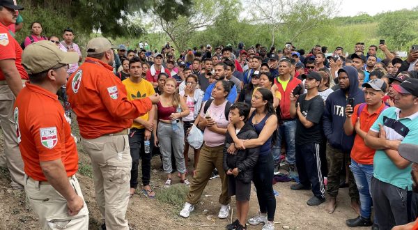 epa10590014 Members of the National Institute of Migration (INM) of Mexico speak with a group of immigrants to discourage them from crossing the Rio Grande river, in Matamoros, Mexico, 24 April 2023. Agents  warned thousands of migrants not to cross the waters of the Rio Grande but hundreds from Central and South America crossed to the US to turn themselves in to the US Border Patrol.  EPA/Abraham Pineda-Jacome