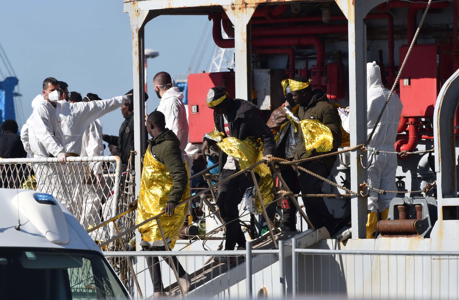 epa10594051 A group of 250 migrants transferred from the hotspot on the island of Lampedusa disembark from the Navy ship Vega in the port of Catania, Italy, 27 April 2023. About 250 migrants are going to disembark from the navy ship in Catania, while another 250 will go down to the port of the Etna capital, and will then be transferred to the first reception center set up in the former vaccination hub of San Giuseppe La Rena. Italian authorities are transferring people away from Lampedusa after the arrival of 1,078 in 20 separate landings the day before, further overcrowding the reception capacity.  EPA/ORIETTA SCARDINO