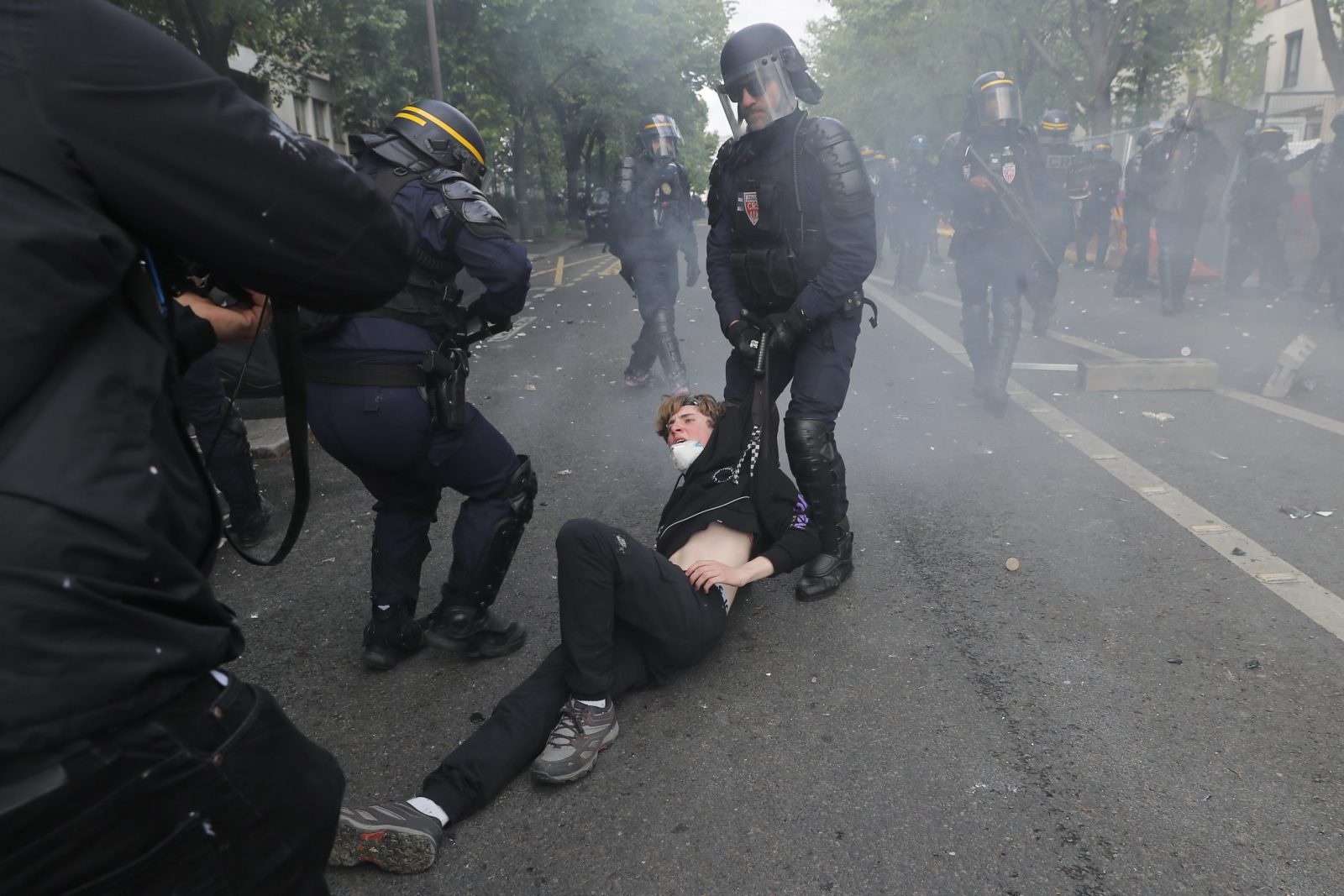 epa10602424 French police officers detain a protester during clashes at the annual May Day march in Paris, France, 01 May 2023. Despite the Constitutional Council's adoption of the law on 14 April raising the retirement age in France from 62 to 64 years old, protests against pension reform are being held in France on this International Workers' Day. Following the filing of a new appeal by the left-wing senators, a new decision is expected on 03 May.  EPA/TERESA SUAREZ