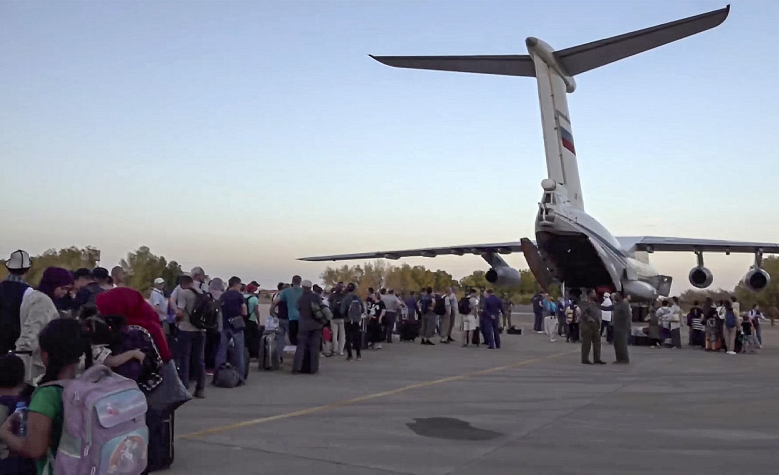 epa10603771 A handout still image taken from a handout video provided by the Russian Defence ministry press-service shows people boarding a Russian military aircraft during a military evacuation operation in the airport of Khartoum, Sudan, 02 May 2023. Four Il-76 aircrafts of the military transport aviation of the Russian Aerospace Forces evacuated more than 200 people from Sudan, employees of the Russian diplomatic mission, representative offices of the Russian Ministry of Defence and their families, citizens of the Russian Federation, CIS countries and a number of friendly foreign states, who asked for assistance in their return to their homelands, according to the Ministry of Defence of the Russian Federation.  EPA/RUSSIAN DEFENCE MINISTRY PRESS SERVICE / HANDOUT  HANDOUT EDITORIAL USE ONLY/NO SALES