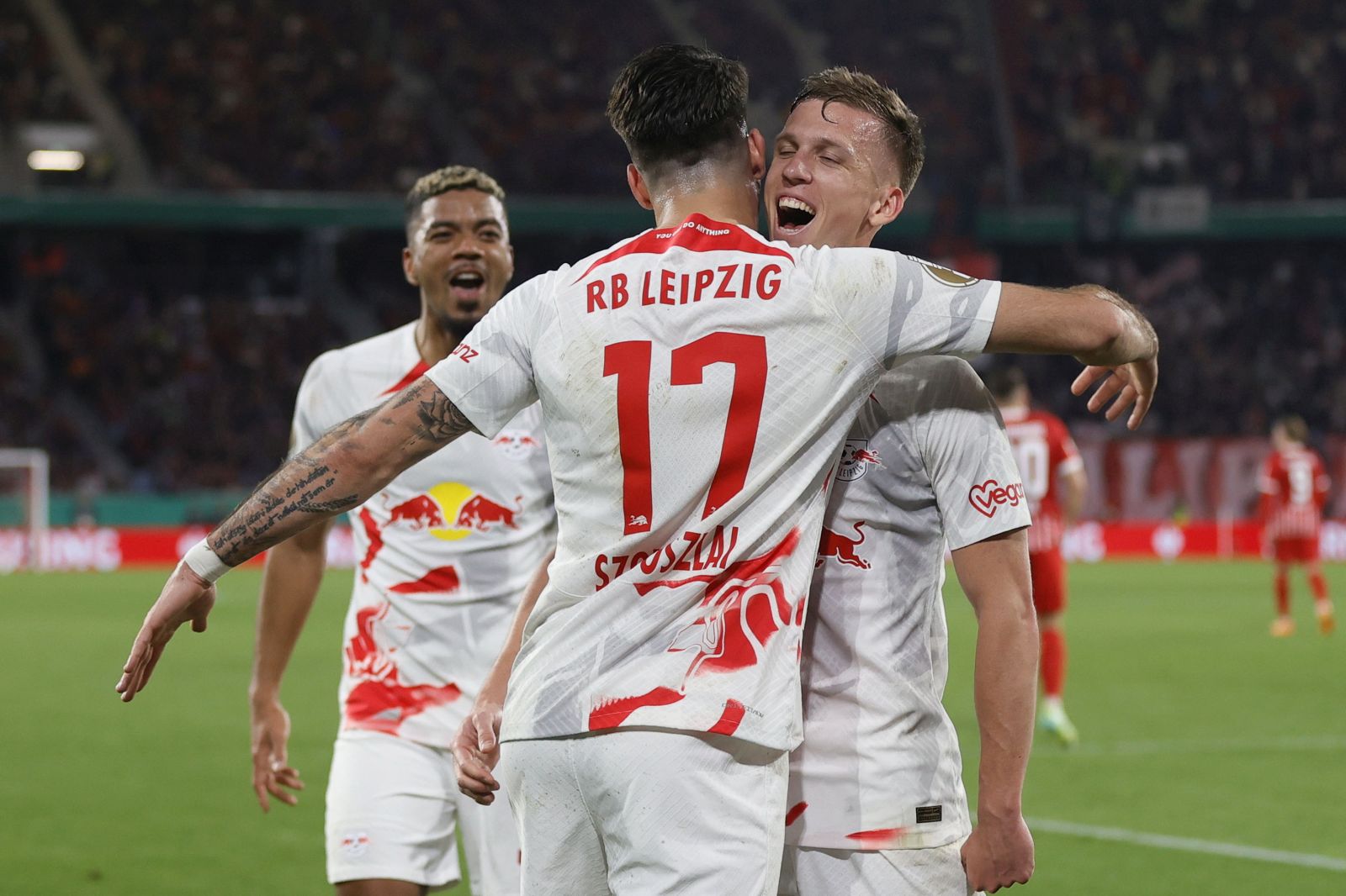 epa10604966 Dominik Szoboszlai of Leipzig celebrates with teammate Daniel Olmo Carvajal (R) after scoring the 0-3 during the DFB Cup semi-final soccer match between SC Freiburg and RasenBallsport Leipzig in Freiburg, Germany, 02 May 2023.  EPA/RONALD WITTEK  ATTENTION:  The DFB regulations prohibit any use of photographs as image sequences and/or quasi-video.