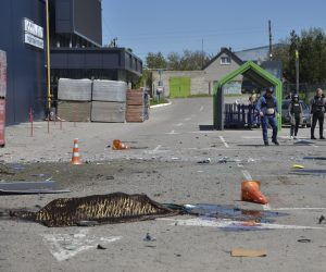 epa10606513 The covered body of a dead person, lies in front of a shelled construction hypermarket in Kherson, Ukraine, 03 May 2023 amid the Russian invasion. Russian troops struck the construction hypermarket, railway station, gas station and residential area of Kherson. At least 16 people were killed and 28 injured by Russian shelling of Kherson region, on 03 May, Roman Mrochko, Head of the Kherson City Military Administration reported.  EPA/IVAN ANTYPENKO