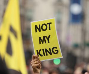 epa10611453 A person raises a placard as anti-monarchy group Republic protest on the day of the Coronation of Britain's King Charles III in London, Britain, 06 May 2023. The group wants to see the hereditary monarchy in Britain abolished and the King replaced by a democratically elected head of state.  EPA/Cathal McNaughton