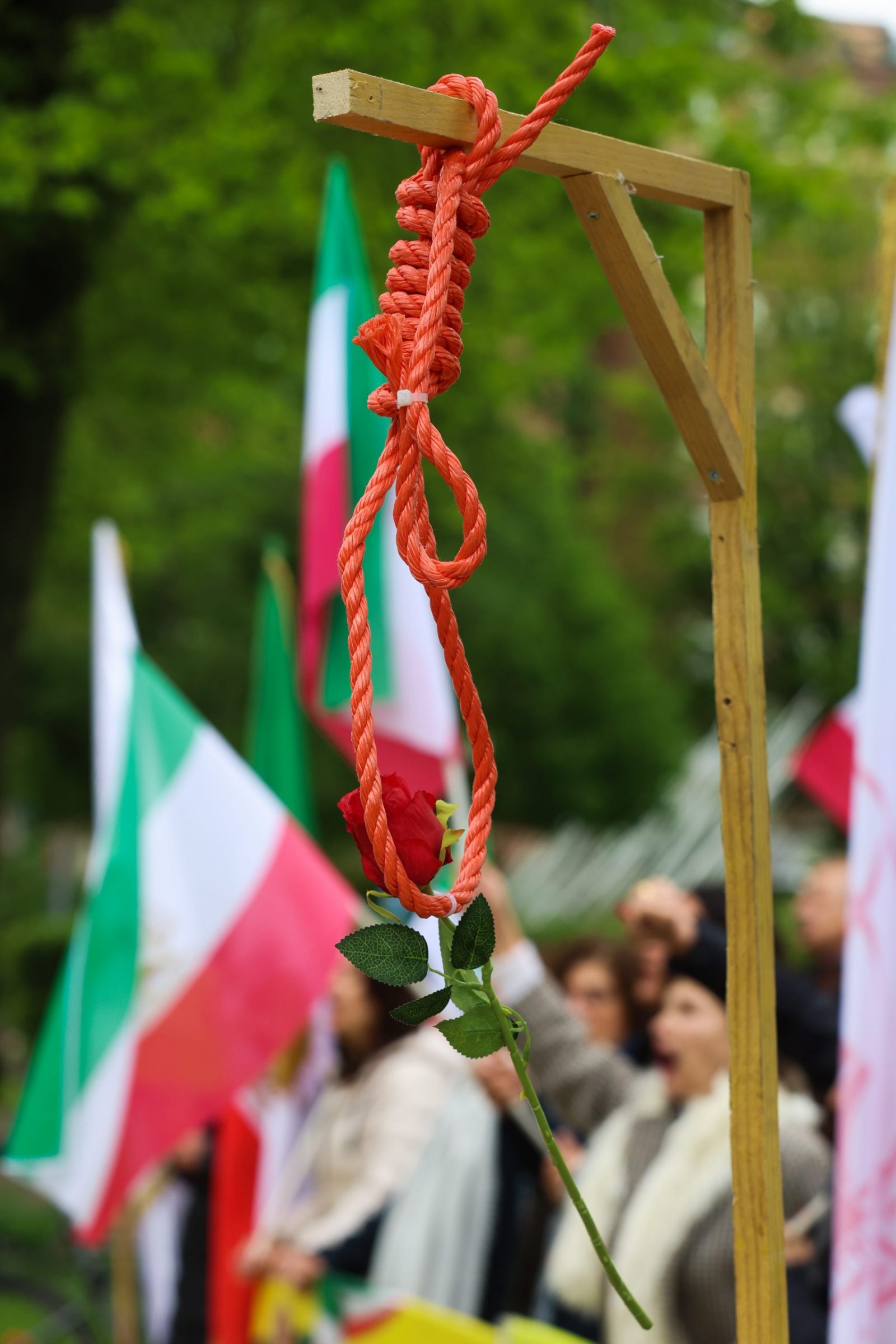 epa10623184 A rose hangs on gallows during a protest by representatives of opposition group the National Council of Resistance of Iran (NCRI) in front of Iranian embassy in Brussels, Belgium, 12 May 2023. According to the NCRI, the protesters are demanding the closure of the Iranian embassy.  EPA/OLIVIER HOSLET