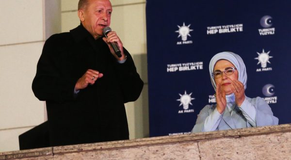 epa10628780 Turkish President and presidential candidate Recep Tayyip Erdogan (L) speaks to supporters at the Justice and Development Party (AKP) headquarters, in Ankara, Turkey, 15 May 2023, the day after simultaneous parliamentary and presidential elections.  EPA/Necati Savas