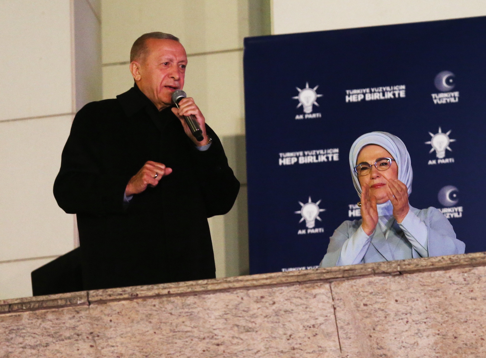 epa10628780 Turkish President and presidential candidate Recep Tayyip Erdogan (L) speaks to supporters at the Justice and Development Party (AKP) headquarters, in Ankara, Turkey, 15 May 2023, the day after simultaneous parliamentary and presidential elections.  EPA/Necati Savas