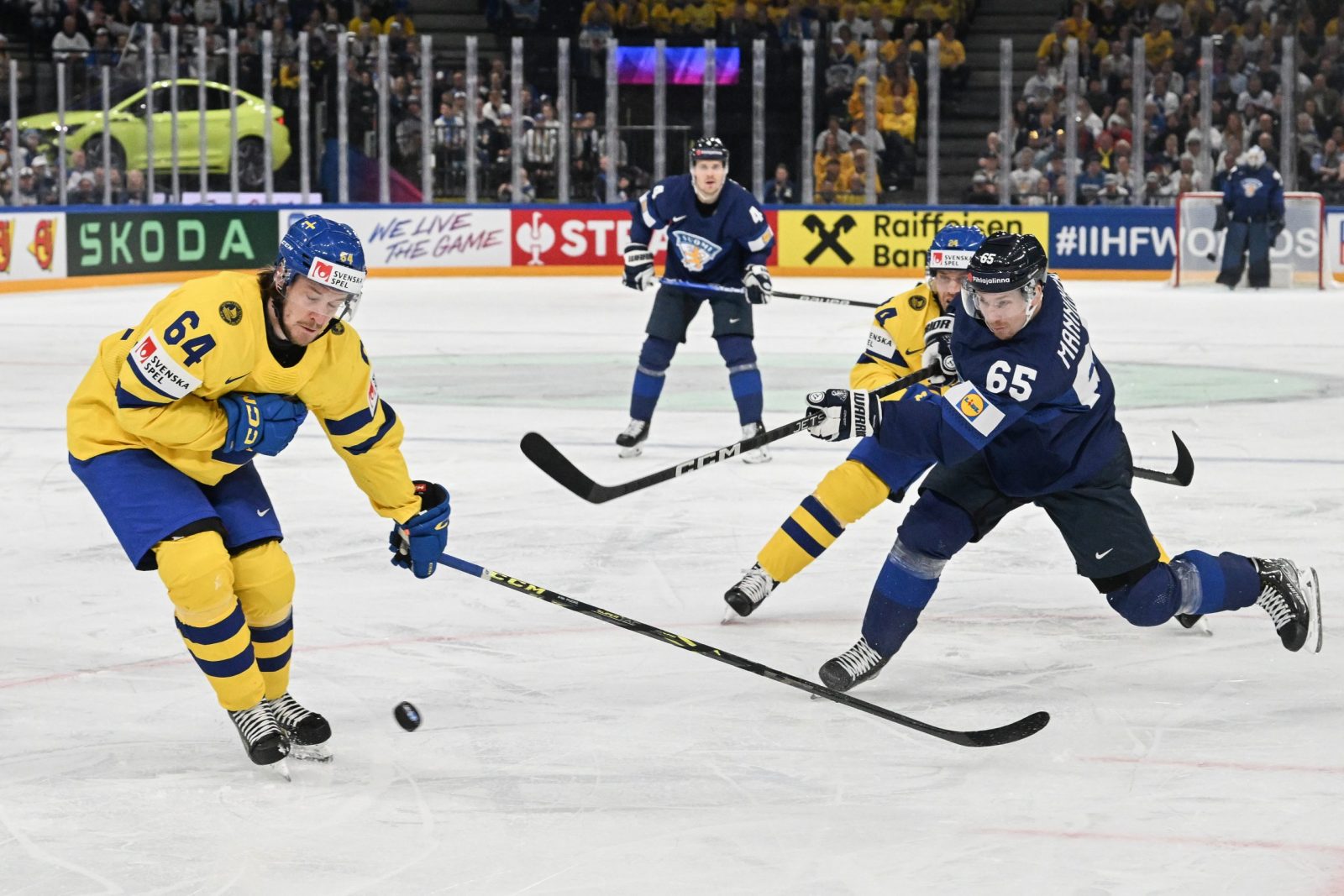 epa10630038 Jonathan Pudas (L) from Sweden and Sakari Manninen from Finland in action during the IIHF 2023 Ice Hockey World Championship first round group A match between Sweden and Finland in Tampere, Finland, 15 May 2023  EPA/KIMMO BRANDT