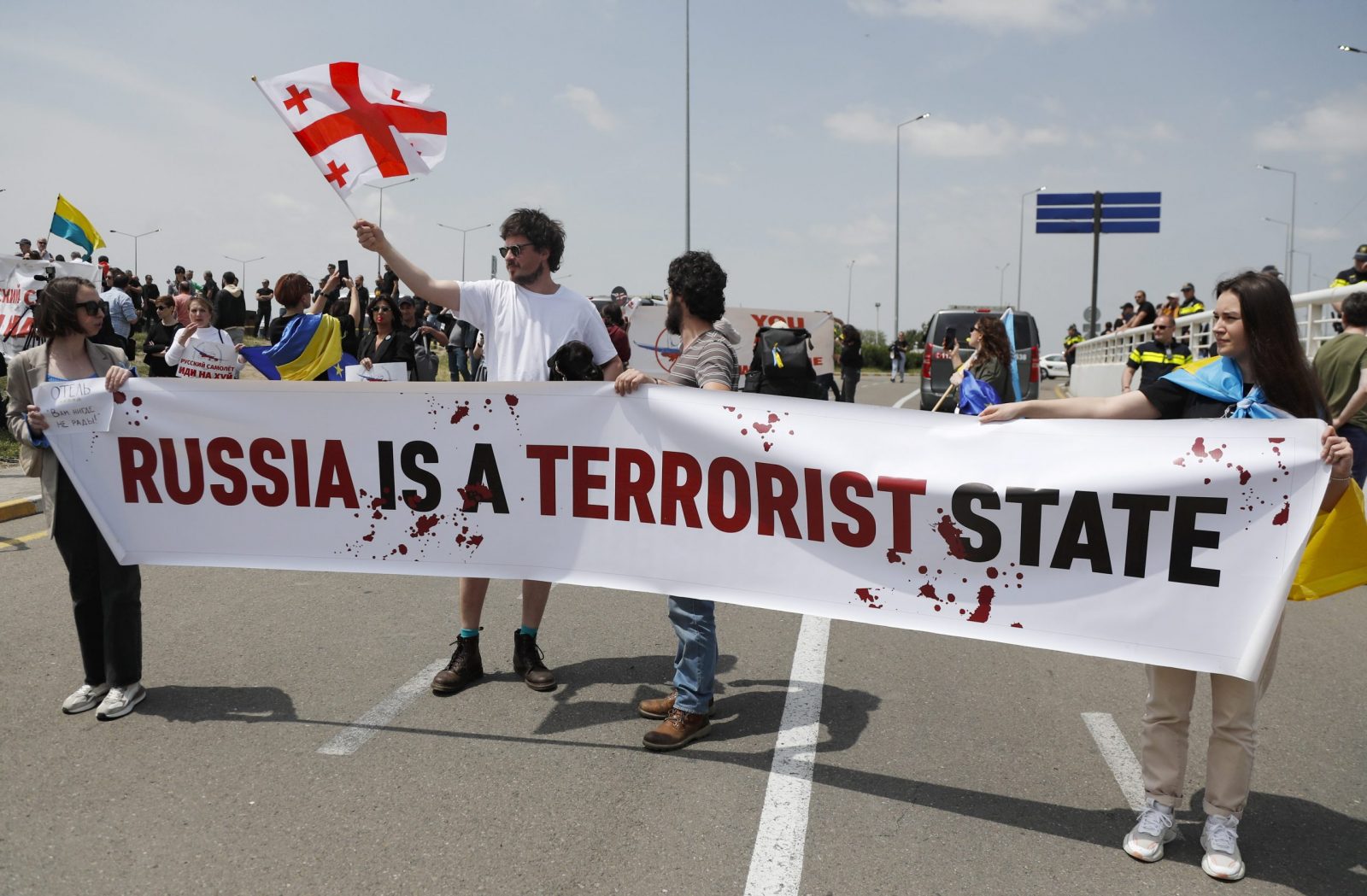 epa10638410 People protest the resumption of air links with Russia during the arrival of the first direct flight of the Russian airline Azimuth, from Moscow to Tbilisi International Airport, in Tbilisi, Georgia, 19 May 2023. Russian President Putin signed a decree to cancel visa requirements for Georgian citizens from 15 May 2023, and lifted the ban on direct flights from Russia to Georgia, which has been in effect since June 2019.  EPA/ZURAB KURTSIKIDZE
