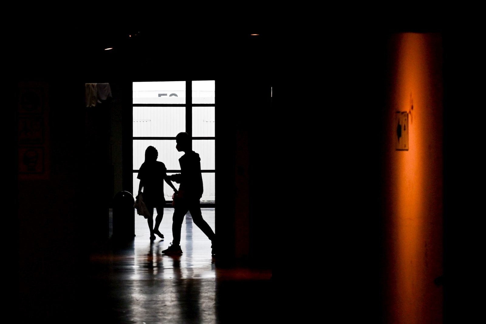 epa10638790 People walk on the hallway of the arrival centre for Ukrainian refugees, at the former Berlin Tegel Airport, in Berlin, Germany, 19 May 2023. The German Red Cross (DRK) has set up an arrival center for refugees in response to their massive arrival in Germany, at the beginning of the Ukrainian crisis in March 2022.  EPA/FILIP SINGER