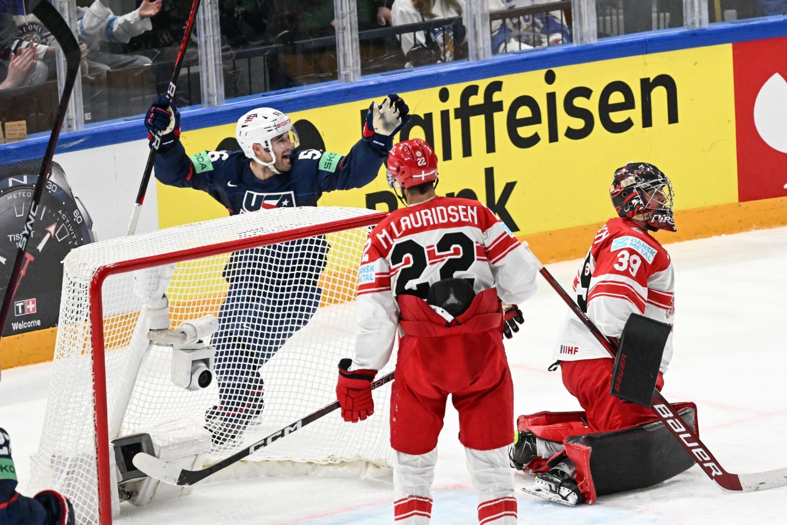 epa10640465 Rocco Grimaldi (L) from USA celebrates a goal during the IIHF 2023 Ice Hockey World Championship group A match between USA and Denmark in Tampere, Finland, 20 May 2023.  EPA/KIMMO BRANDT
