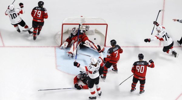 epa10641243 Switzerland's forward Andres Ambuehl (L) celebrates with his teammates Switzerland's defender Michael Fora (C) and Switzerland's forward Enzo Corvi (R) after scoring the 3-1 lead during the group B match between Canada and Switzerland at the IIHF 2023 Ice Hockey World Championship, in Riga, Latvia, 20 May 2023.  EPA/SALVATORE DI NOLFI