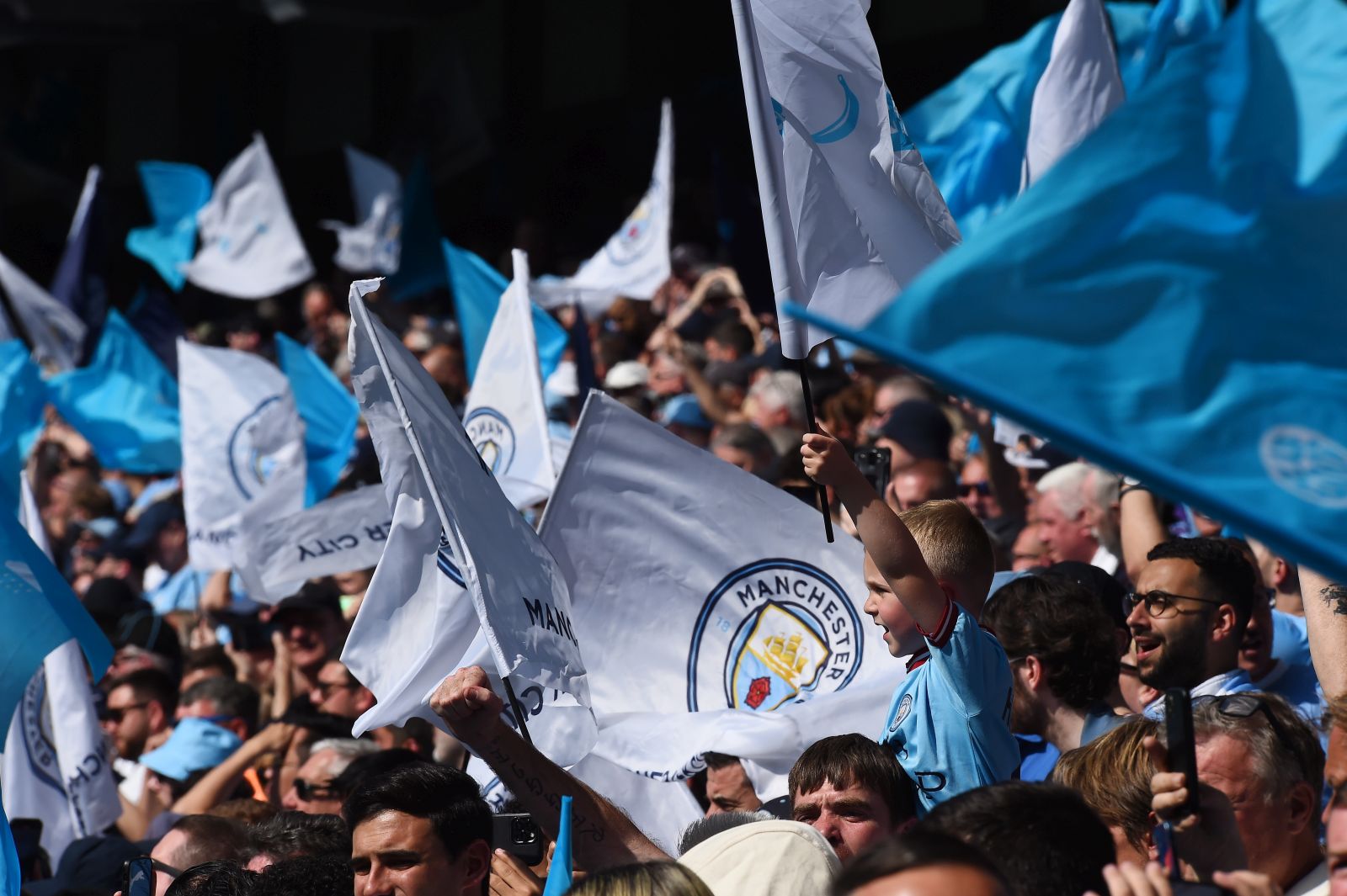 epa10643851 Manchester City's fans wave flags during the English Premier League soccer match between Manchester City and Chelsea at the Etihad in Manchester, Britain, 21 May 2023.  EPA/Peter Powell EDITORIAL USE ONLY. No use with unauthorized audio, video, data, fixture lists, club/league logos or 'live' services. Online in-match use limited to 120 images, no video emulation. No use in betting, games or single club/league/player publications