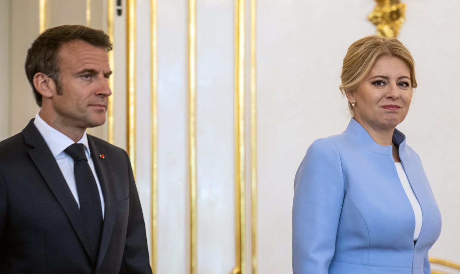 epa10664392 Slovak President Zuzana Caputova (R) and French Presiden Emmanuel Macron (L) arrive for a meeting at the Grassalkovich Palace, official seat of the Slovak President, in Bratislava, Slovakia, 31 May 2023.  EPA/CHRISTIAN BRUNA